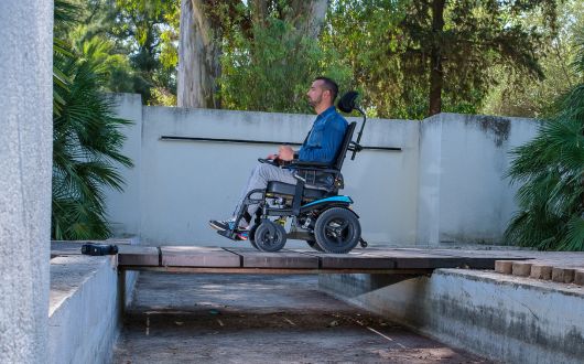 Man using powerchair over bridge