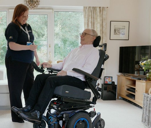 Representative and customer in powerchair.