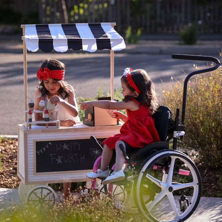 Children playing whilst one is using the Little Wave Clik wheelchair