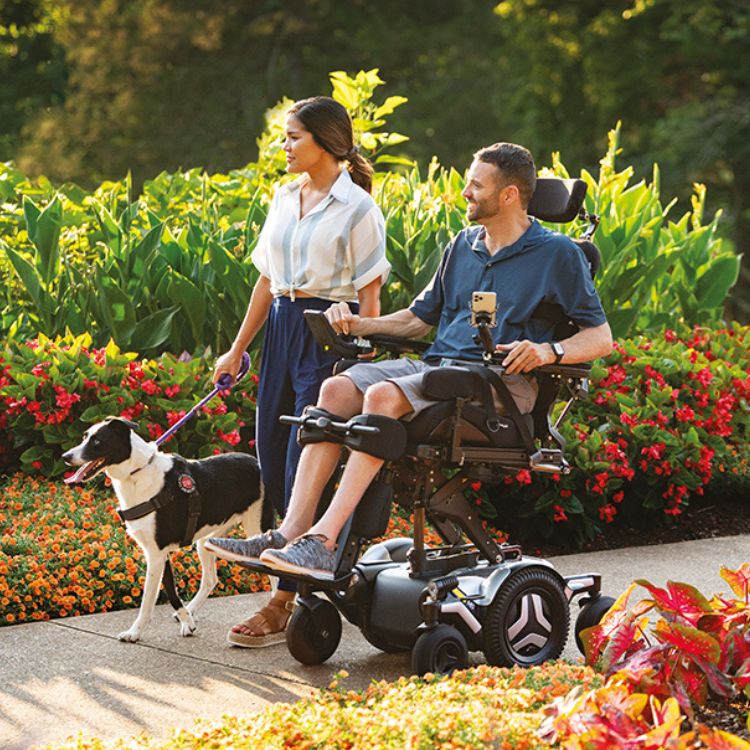 Couple in a park with man using M5 Corpus powerchair