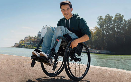 Man using wheelchair near water