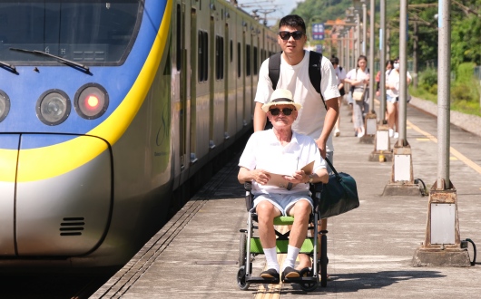 Man pushing another man using wheelchair