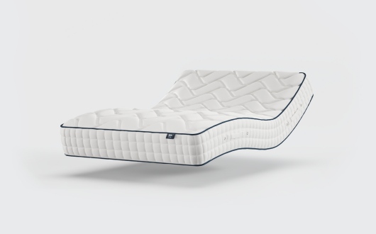 An adjustable white Opera Gel 1000 Mattress with a quilted pattern is shown in a raised, curved position, appearing to float against a plain white background.