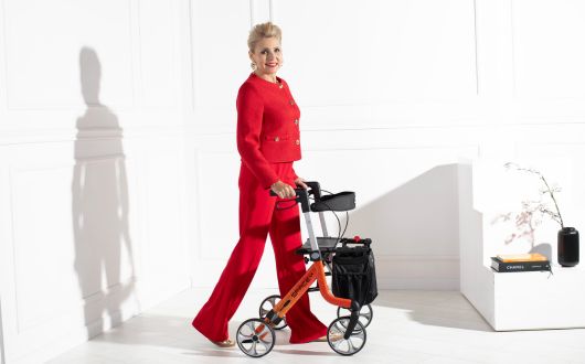 Woman using Space LX rollator in cloud design