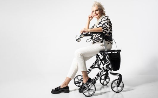 Woman sitting on Space LX rollator in Zebra design