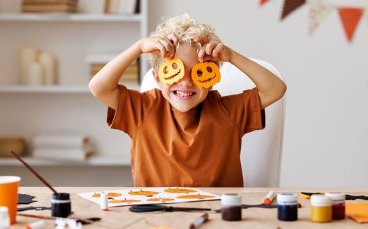 Boy making Halloween decorations