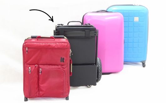 eFoldi Lite folded next to suitcases