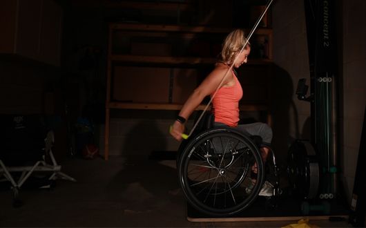 Woman using Octane FX wheelchair in gym