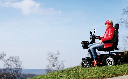 Woman using S700 mobility scooter outdoors