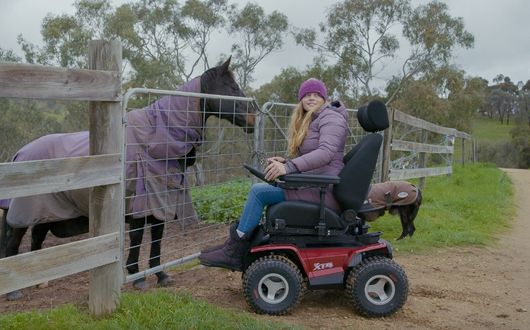 Woman using XT4 powerchair outdoors