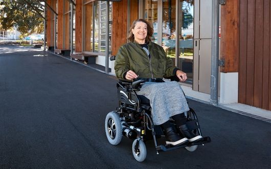 Woman using powerchair outdoors
