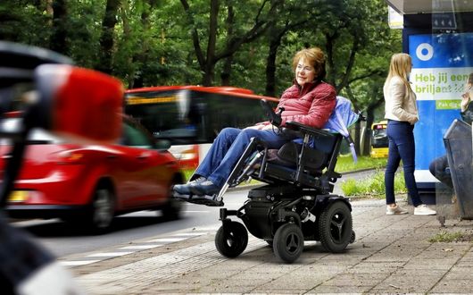 Woman using powerchair outdoors