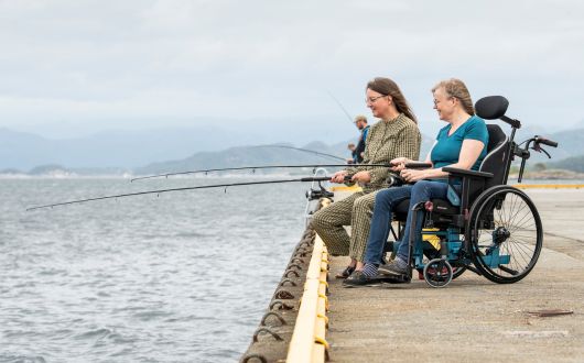 Woman using Netti V wheelchair whilst fishing