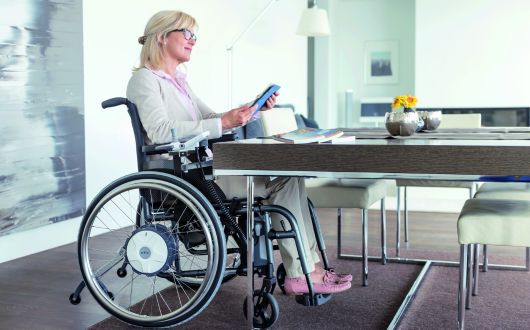 Woman using Alber E-Fix powerchair indoors
