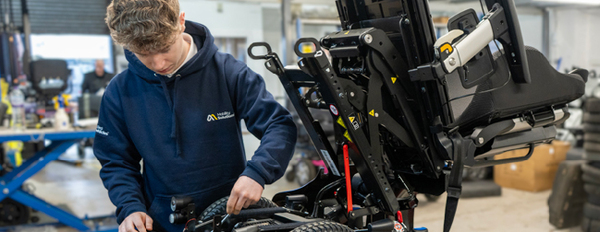 mobility solutions staff inspecting chair
