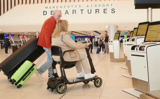 Woman using mobility scooter at airport