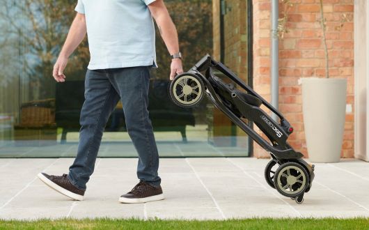 Man pulling folded mobility scooter like a trolly/suitcase