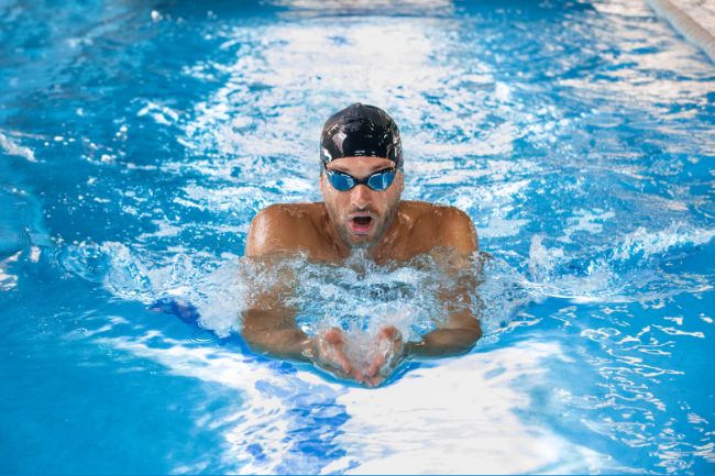 Man swimming in pool.