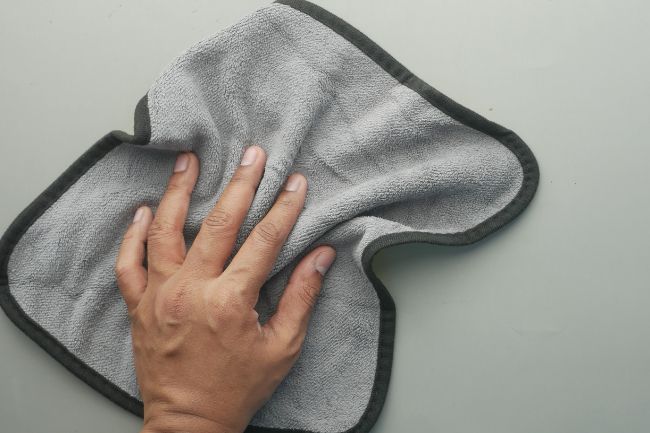 Hand with a cleaning cloth.